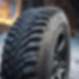 Close-up view of a snow tire's tread pattern highlighting traction capabilities.