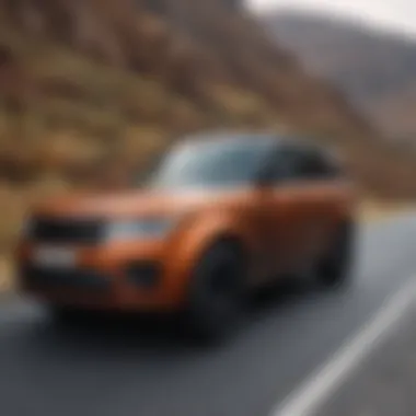 High-performance burnt orange Range Rover on a scenic road