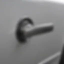 Close-up of a car interior door handle showing wear and tear