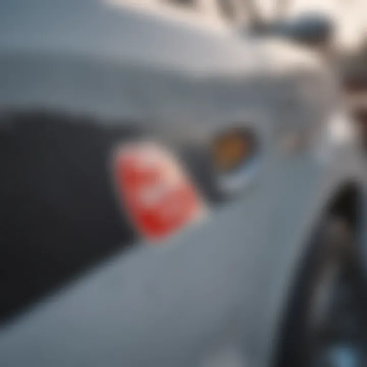 Close-up of a car surface showing a sticker being removed