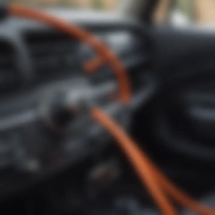 Close-up of an aux cord connected to an iPhone in a car