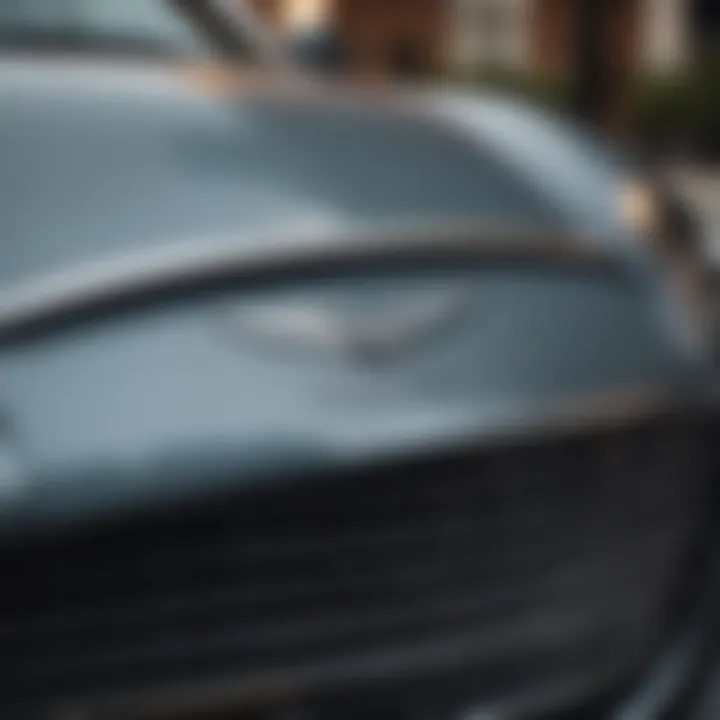 Close-up of Aston Martin emblem on a car grill