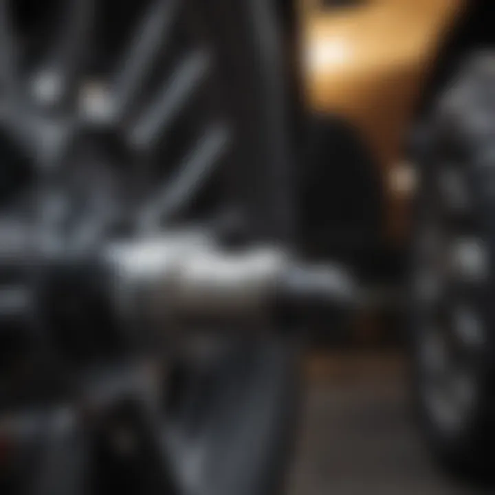 Close-up of an electric impact wrench gripping a lug nut